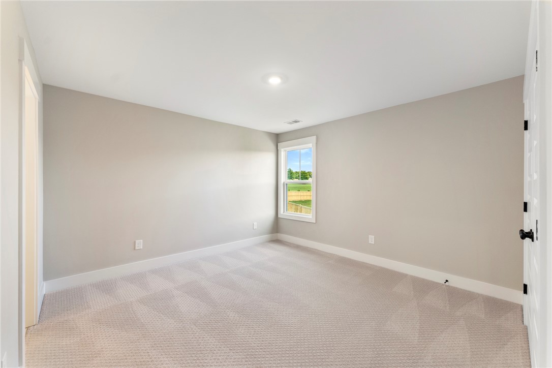 133 Osprey Landing Central, SC 29630 - Photo 24 of 34 This spacious bedroom offers ample natural light and plush carpeting for comfort.