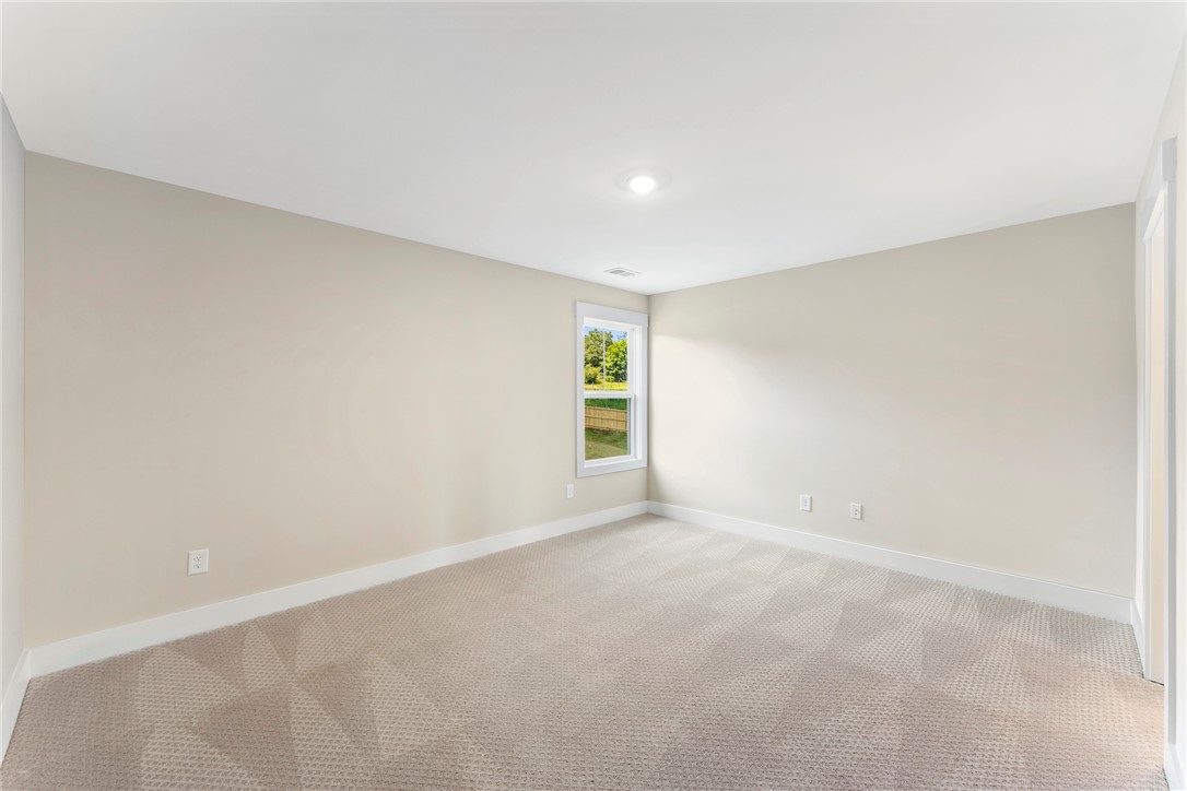 133 Osprey Landing Central, SC 29630 - Photo 27 of 34 Bright and airy, this room features ample natural light and plush carpeting.