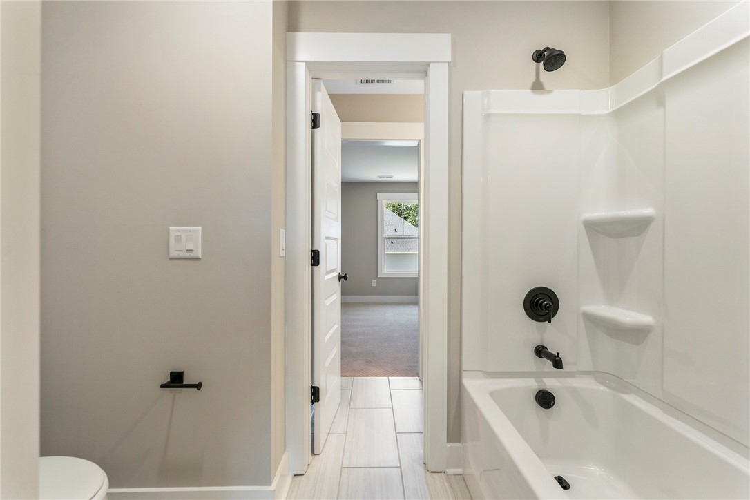 133 Osprey Landing Central, SC 29630 - Photo 30 of 34 This clean and bright bathroom features a tub-shower combination, ideal for unwinding.