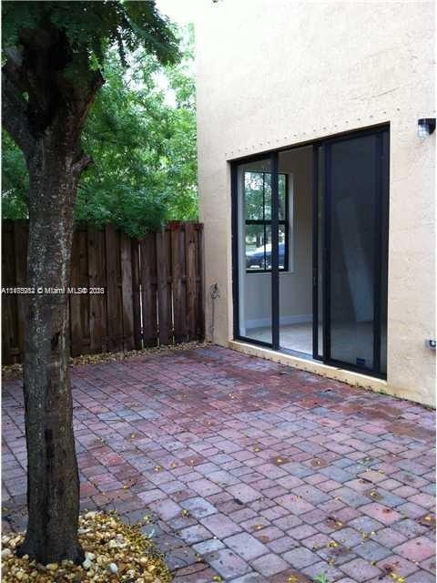 11459 Southwest 238th Street, Unit 11459 Homestead, FL 33032 - Photo 11 of 12 a view of backyard with tub and wooden fence