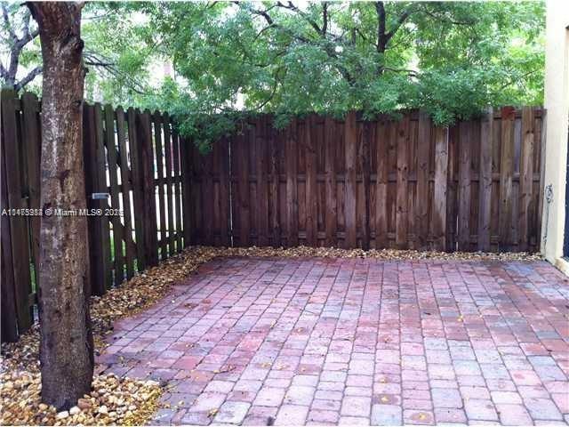 11459 Southwest 238th Street, Unit 11459 Homestead, FL 33032 - Photo 12 of 12 a wooden fence with trees in front of it