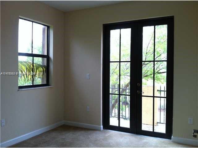 11459 Southwest 238th Street, Unit 11459 Homestead, FL 33032 - Photo 6 of 12 an empty room with large windows