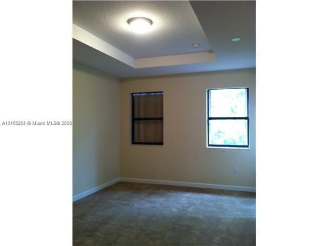 11459 Southwest 238th Street, Unit 11459 Homestead, FL 33032 - Photo 8 of 12 a view of an empty room with a window