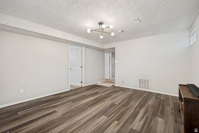 1215 8th Street Ogden, UT 84404 - Photo 31 of 39 Versatile room featuring wood-finish flooring, light gray wall paint, and a modern ceiling light fixture
