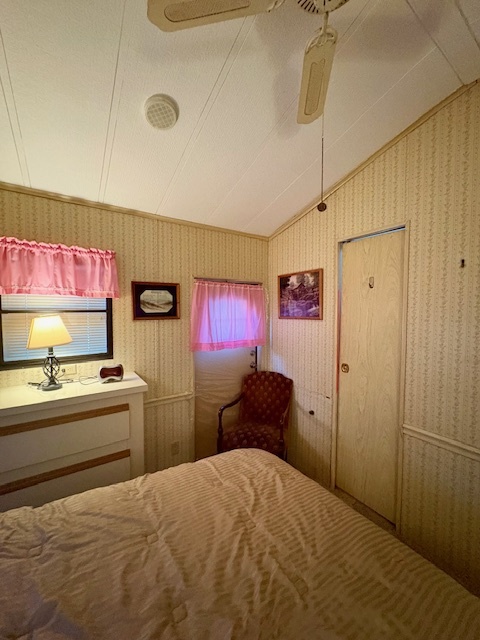 4-20 Woodhaven Sublette, IL 61367 - Photo 23 of 26 a bedroom with a bed and a chandelier