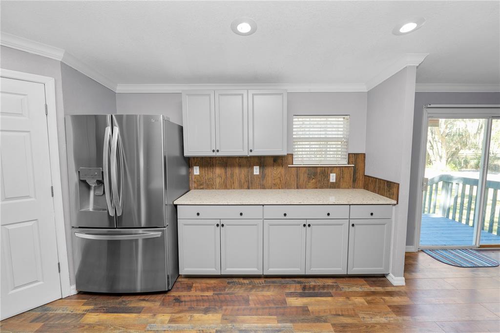 7405 Shoupe Road Plant City, FL 33565 - Photo 11 of 61 a kitchen with a refrigerator sink and cabinets