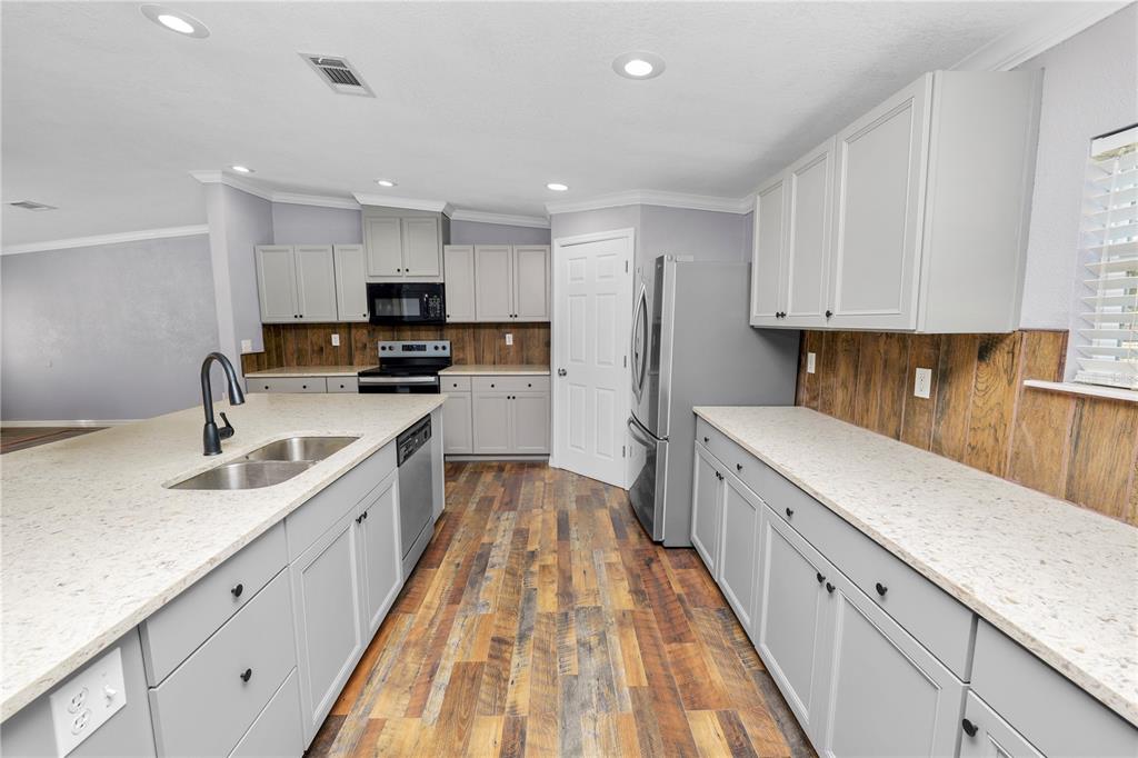 7405 Shoupe Road Plant City, FL 33565 - Photo 13 of 61 a large kitchen with stainless steel appliances granite countertop a lot of counter space and wooden floors