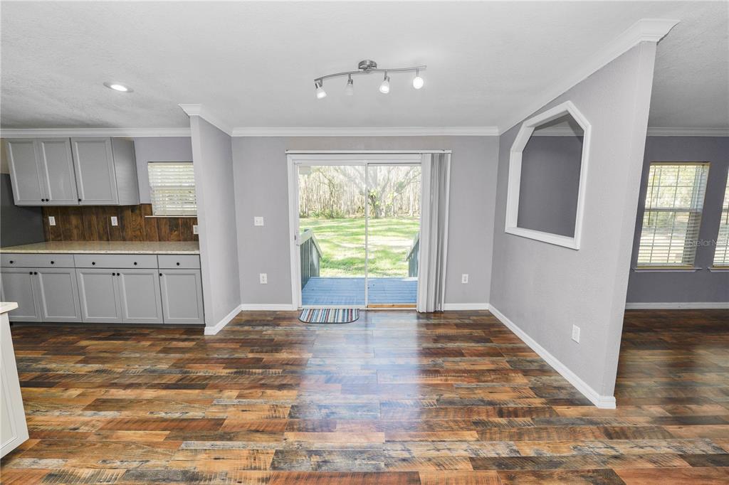 7405 Shoupe Road Plant City, FL 33565 - Photo 14 of 61 a view of a kitchen with wooden floor and windows