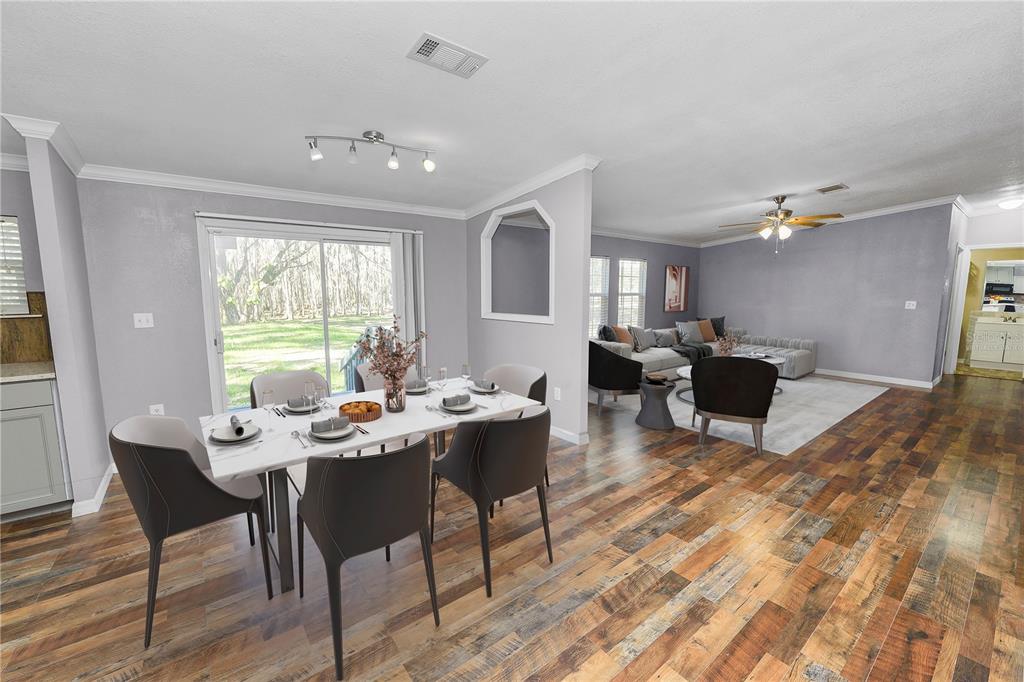 7405 Shoupe Road Plant City, FL 33565 - Photo 15 of 61 a view of a dining room with furniture window and wooden floor