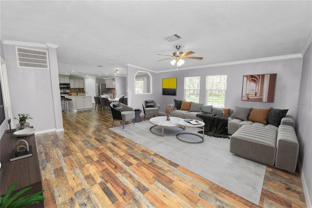 7405 Shoupe Road Plant City, FL 33565 - Photo 18 of 61 a living room with furniture and a wooden floor