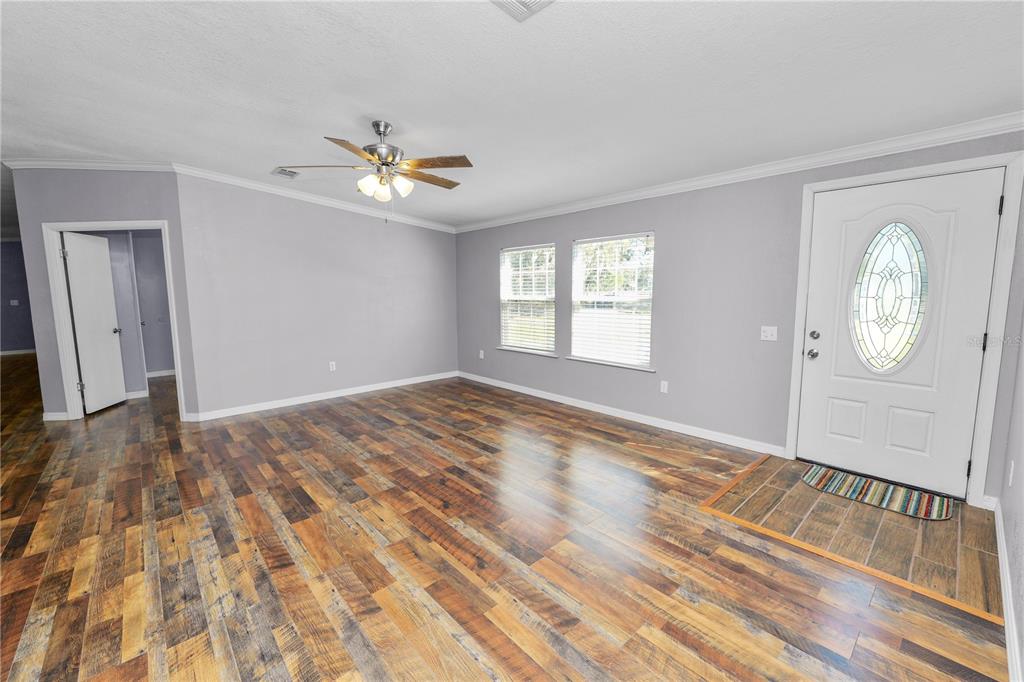 7405 Shoupe Road Plant City, FL 33565 - Photo 2 of 61 wooden floor in an empty room with a window