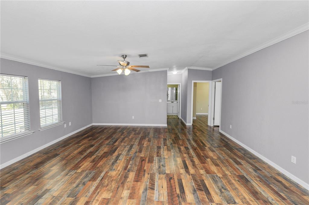 7405 Shoupe Road Plant City, FL 33565 - Photo 22 of 61 wooden floor in an empty room with a window