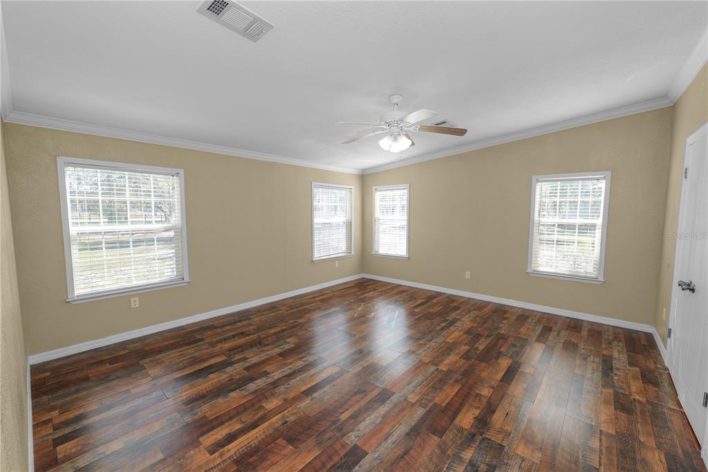 7405 Shoupe Road Plant City, FL 33565 - Photo 24 of 61 a view of an empty room with a window and wooden floor