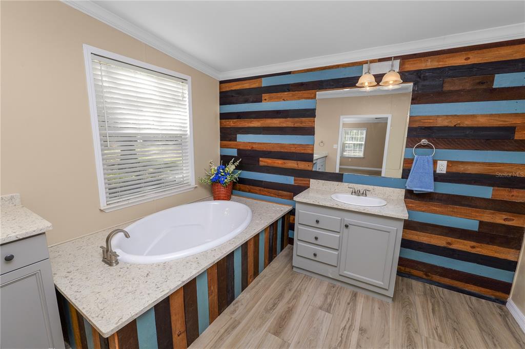 7405 Shoupe Road Plant City, FL 33565 - Photo 29 of 61 a bathroom with a granite countertop sink and a mirror