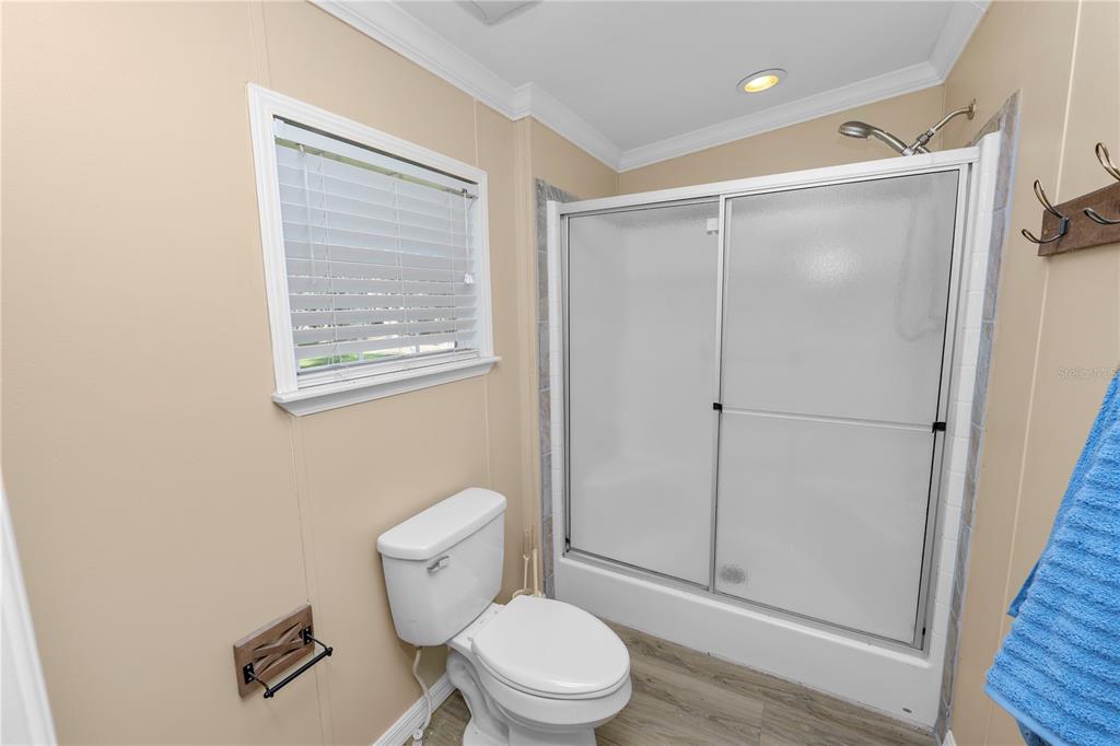 7405 Shoupe Road Plant City, FL 33565 - Photo 31 of 61 a bathroom with a toilet and a shower