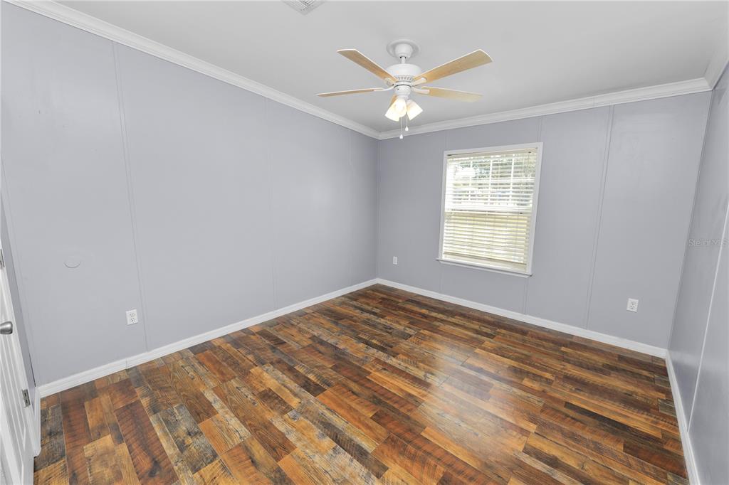 7405 Shoupe Road Plant City, FL 33565 - Photo 33 of 61 wooden floor in an empty room with a window