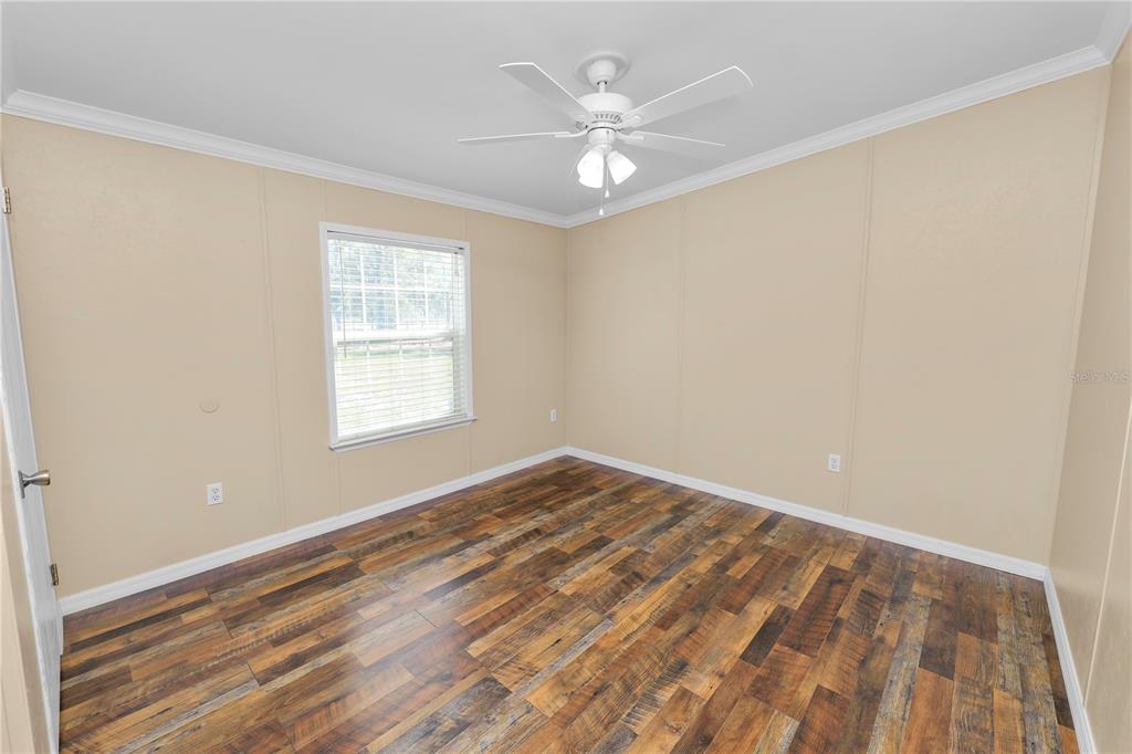 7405 Shoupe Road Plant City, FL 33565 - Photo 37 of 61 wooden floor in an empty room with a window