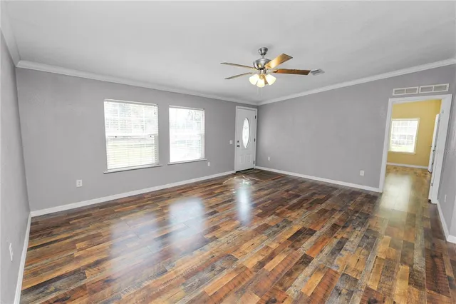 wooden floor in an empty room with a window