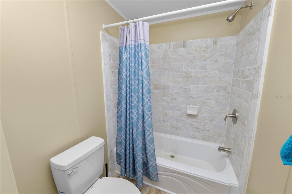 7405 Shoupe Road Plant City, FL 33565 - Photo 41 of 61 a bathroom with a toilet and shower