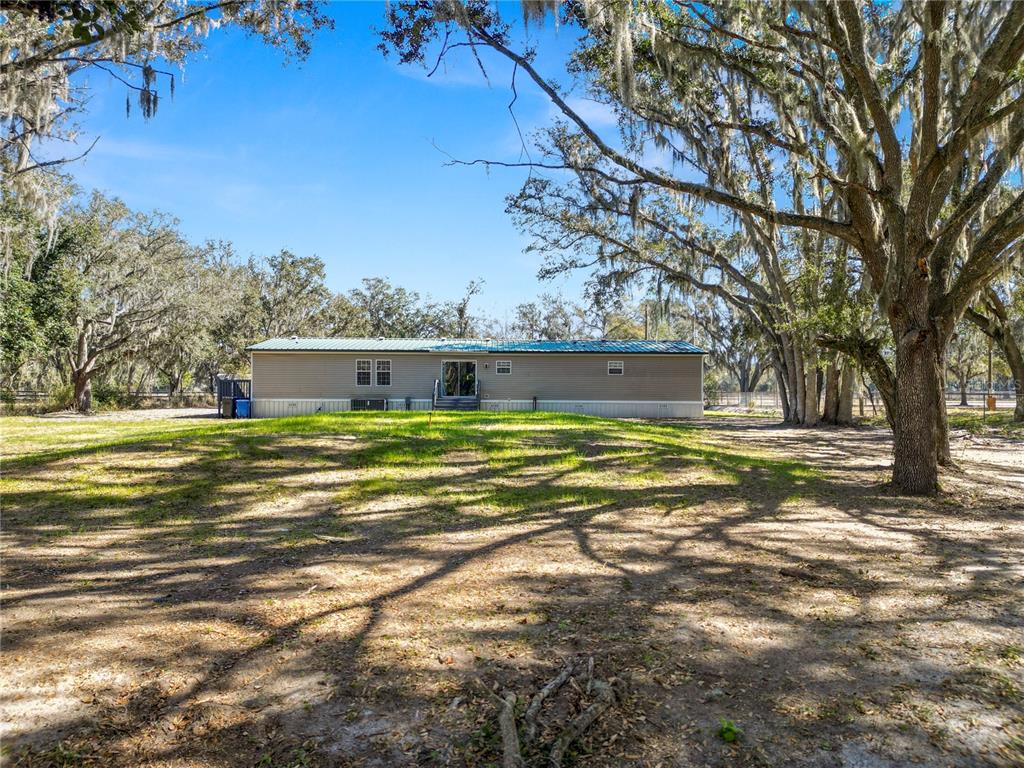 7405 Shoupe Road Plant City, FL 33565 - Photo 59 of 61 a view of a house with a yard