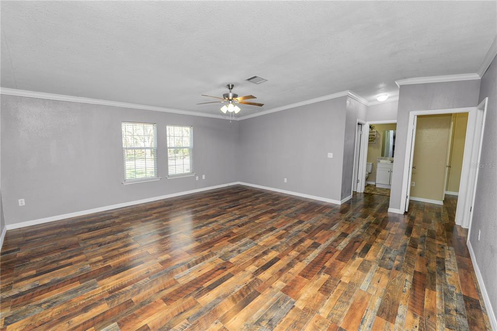 7405 Shoupe Road Plant City, FL 33565 - Photo 6 of 61 wooden floor in an empty room with a window