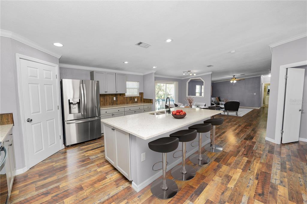 7405 Shoupe Road Plant City, FL 33565 - Photo 9 of 61 a kitchen with kitchen island a sink stove and refrigerator
