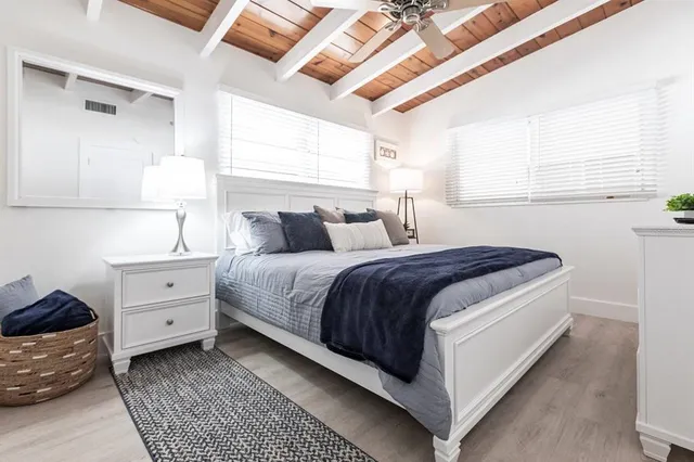 a spacious bedroom with a bed and a window