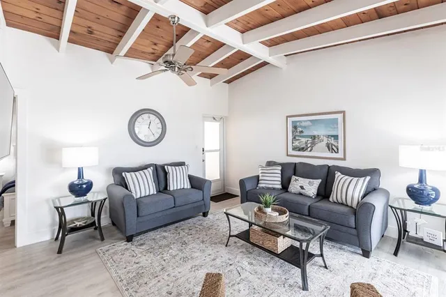 a living room with furniture and a clock
