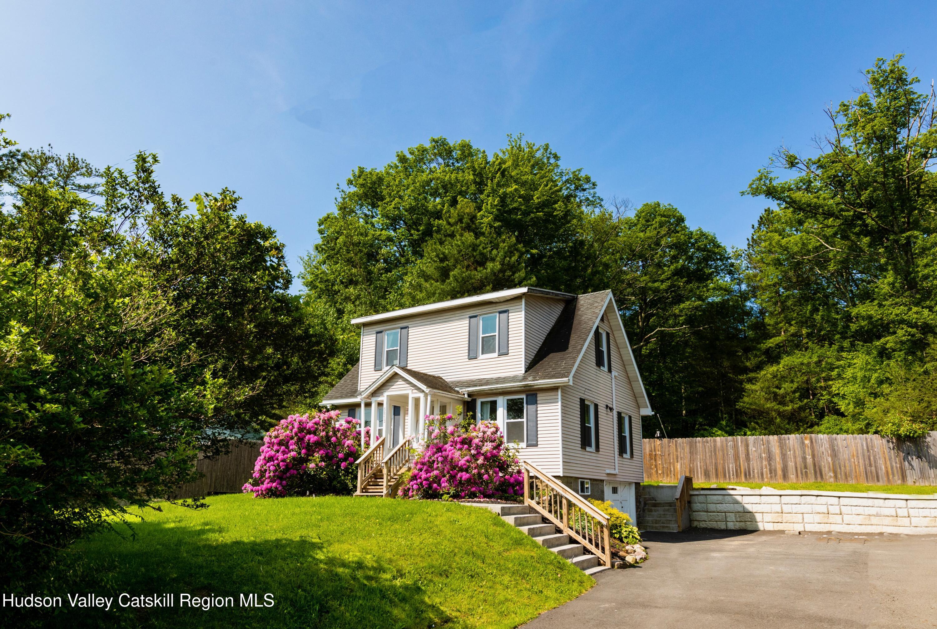 5813 Highway 44 Kerhonkson, NY 12446 - Photo 1 of 21 a front view of a house with a garden