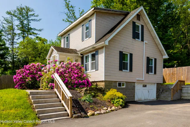 a front view of a house with a yard and outdoor seating