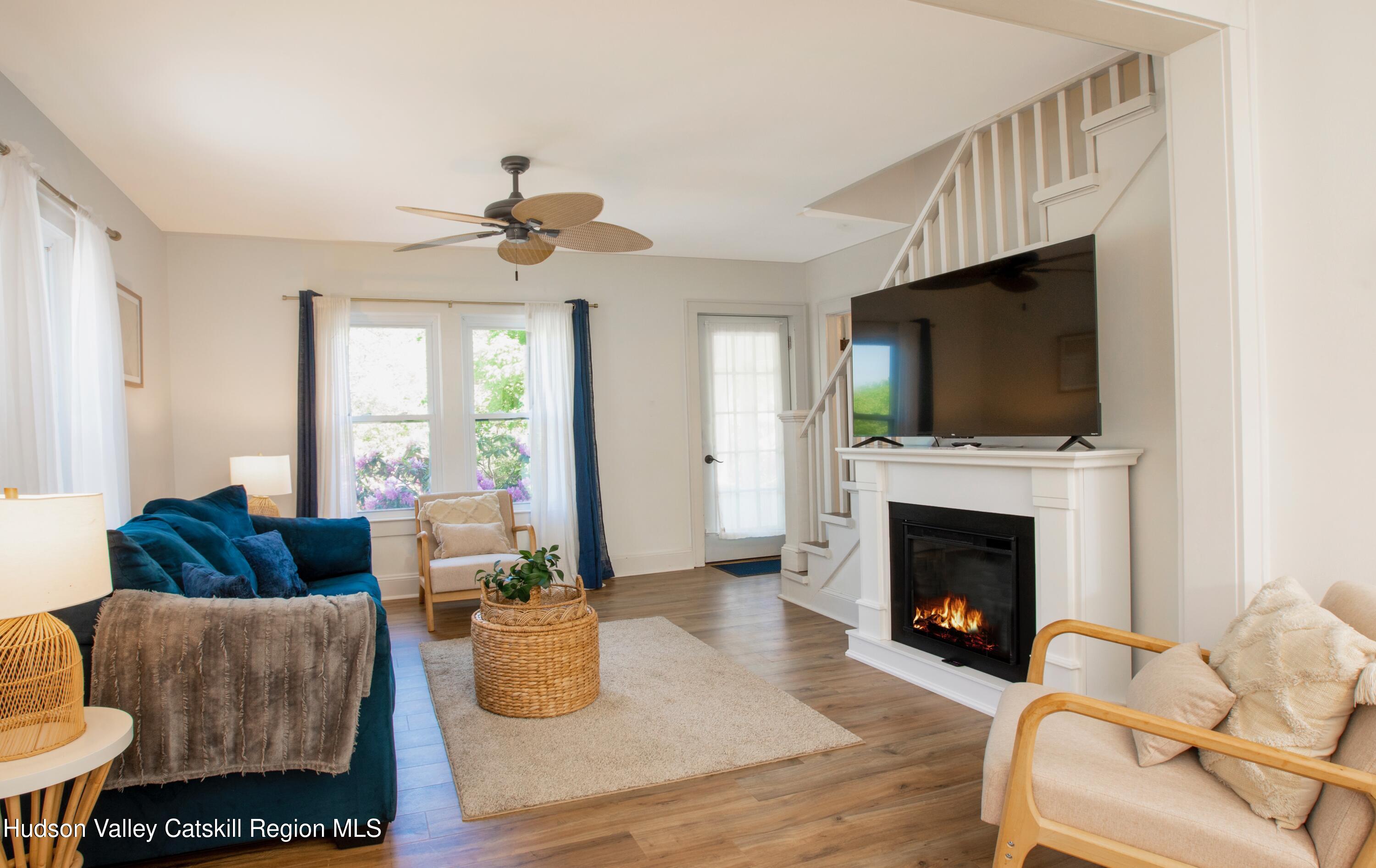 5813 Highway 44 Kerhonkson, NY 12446 - Photo 3 of 21 a living room with furniture a flat screen tv and a fireplace