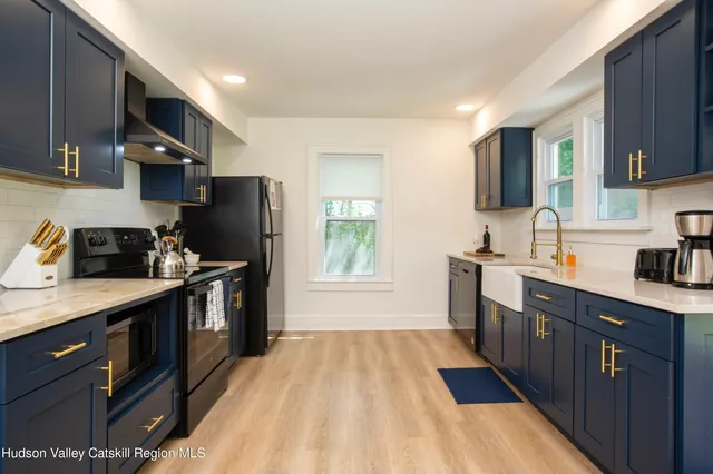a kitchen with a sink a refrigerator and cabinets