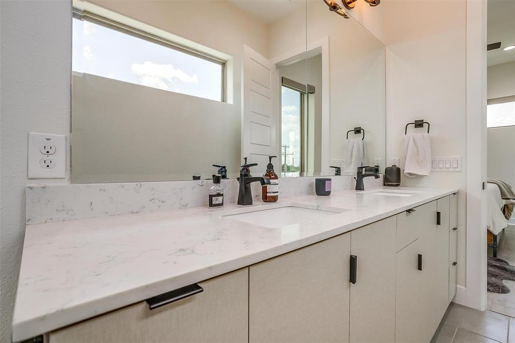 3231 Elihu Street, Unit 101 Dallas, TX 75210 - Photo 15 of 20 a bathroom with a sink and a mirror