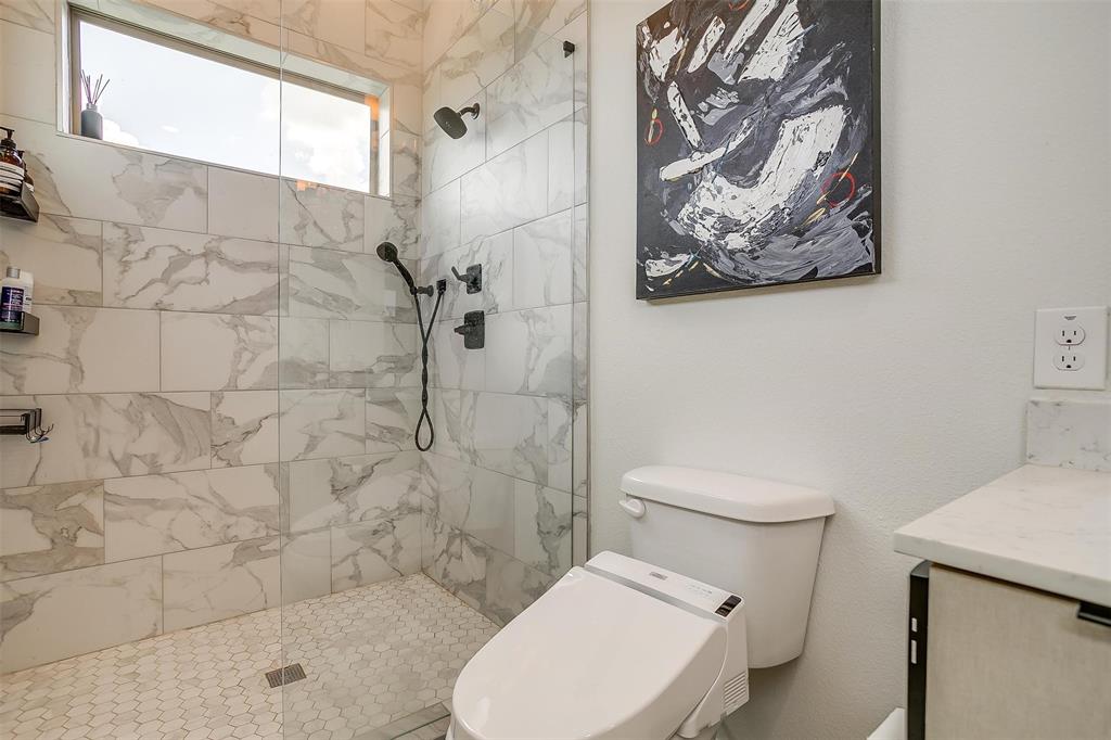 3231 Elihu Street, Unit 101 Dallas, TX 75210 - Photo 16 of 20 a white toilet sitting next to a bathroom sink