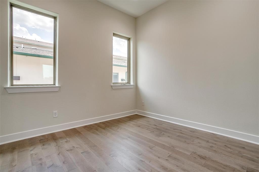 3231 Elihu Street, Unit 101 Dallas, TX 75210 - Photo 17 of 20 an empty room with wooden floor and windows