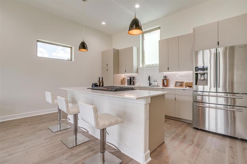3231 Elihu Street, Unit 101 Dallas, TX 75210 - Photo 3 of 20 a kitchen with a refrigerator and white cabinets