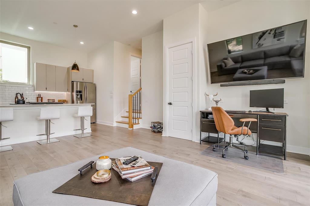 3231 Elihu Street, Unit 101 Dallas, TX 75210 - Photo 4 of 20 a living room with furniture kitchen and a flat screen tv