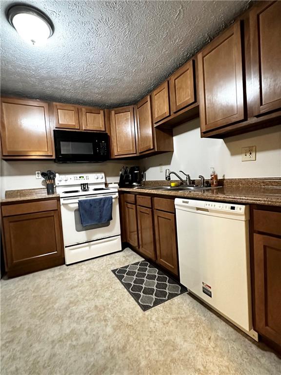 1205 Dutilh Road, Unit 1 Cranberry Township, PA 16066 - Photo 13 of 32 a kitchen with stainless steel appliances granite countertop a stove a sink and a microwave