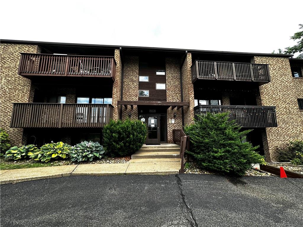 1205 Dutilh Road, Unit 1 Cranberry Township, PA 16066 - Photo 2 of 32 a front view of a house with a yard