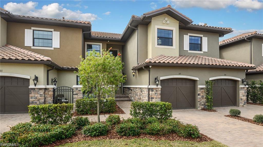 9685 Montelanico Loop, Unit 202 Naples, FL 34119 - Photo 1 of 21 a front view of a house with a garden