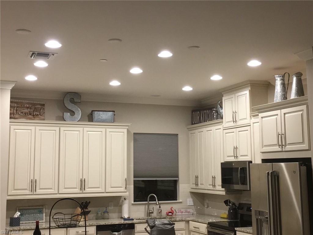 9685 Montelanico Loop, Unit 202 Naples, FL 34119 - Photo 14 of 21 a view of kitchen with stainless steel appliances granite countertop a refrigerator a stove and a sink