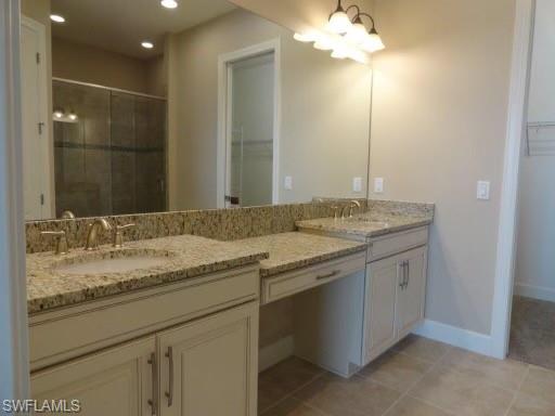 9685 Montelanico Loop, Unit 202 Naples, FL 34119 - Photo 16 of 21 a bathroom with a granite countertop sink a large mirror and a shower