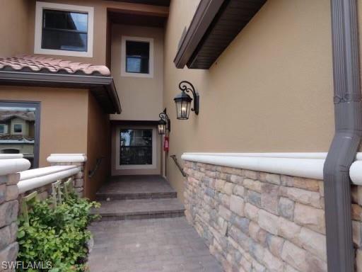 9685 Montelanico Loop, Unit 202 Naples, FL 34119 - Photo 21 of 21 a front view of a house with entryway