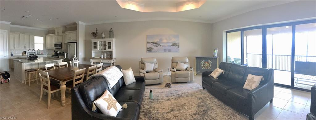 9685 Montelanico Loop, Unit 202 Naples, FL 34119 - Photo 3 of 21 a living room with furniture large window and wooden floor