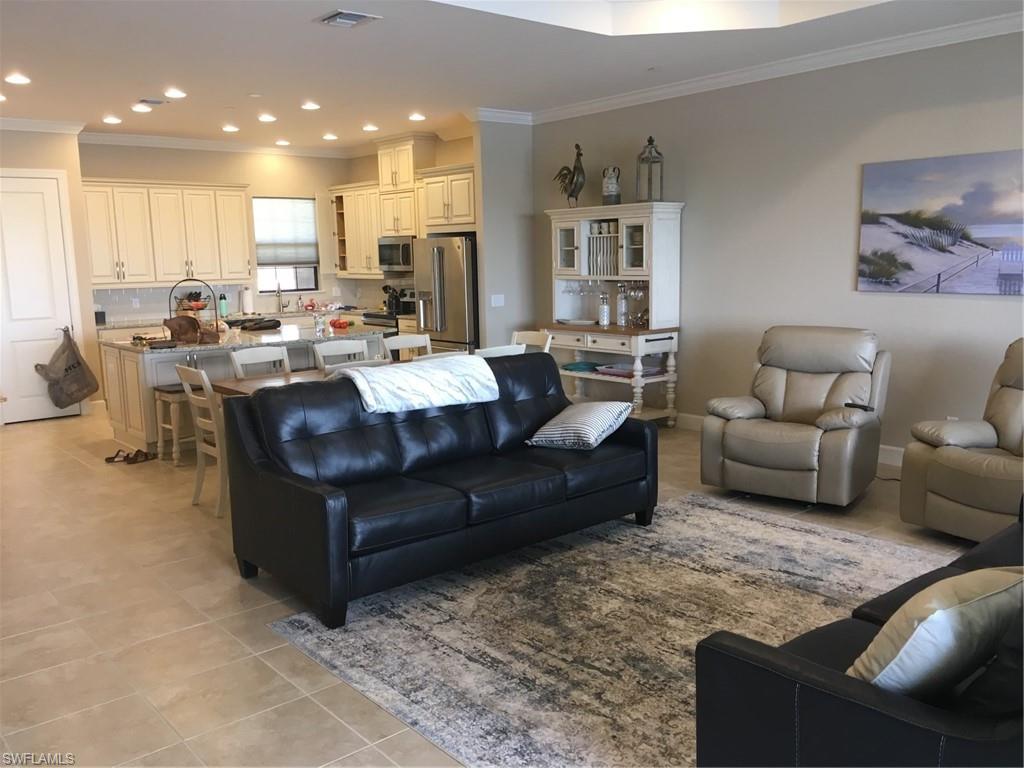 9685 Montelanico Loop, Unit 202 Naples, FL 34119 - Photo 4 of 21 a living room with furniture kitchen view and a large window