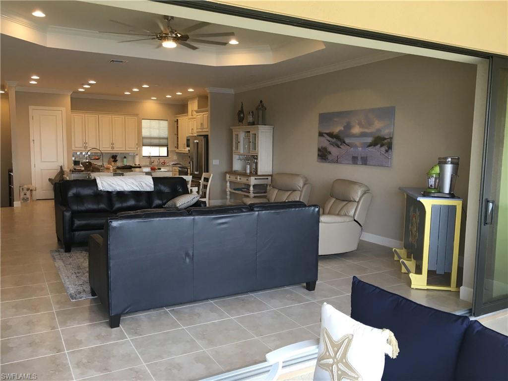 9685 Montelanico Loop, Unit 202 Naples, FL 34119 - Photo 6 of 21 a kitchen with a sink cabinets and wooden floor