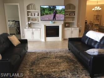 9685 Montelanico Loop, Unit 202 Naples, FL 34119 - Photo 8 of 21 a living room with furniture and a fireplace