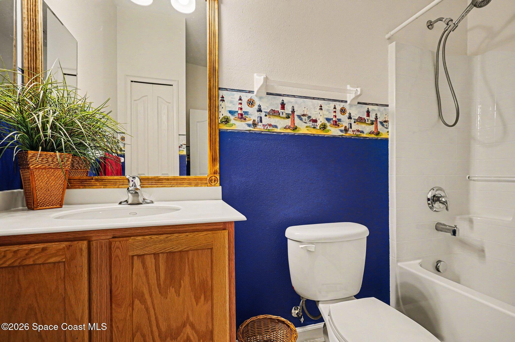 6973 Premonition Drive Melbourne, FL 32940 - Photo 16 of 91 a bathroom with a sink a toilet and shower