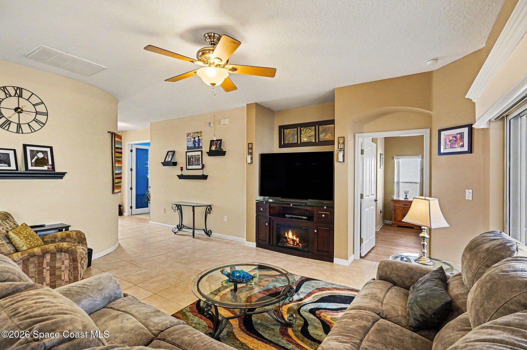 6973 Premonition Drive Melbourne, FL 32940 - Photo 5 of 91 a living room with furniture and a flat screen tv