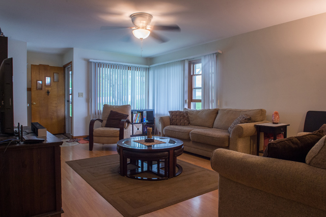 504 East Cleveland Street Spring Valley, IL 61362 - Photo 4 of 18 a living room with furniture a chandelier and a window